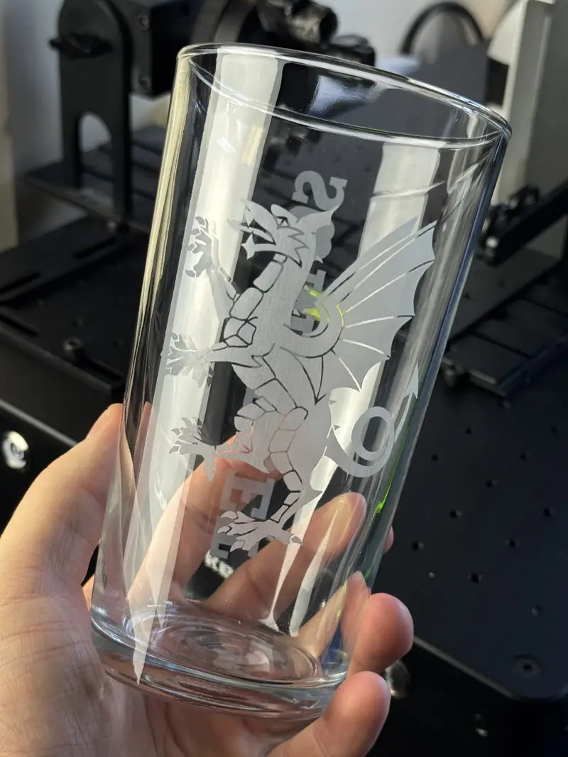 The back of the same cider pint, engraved with a second design