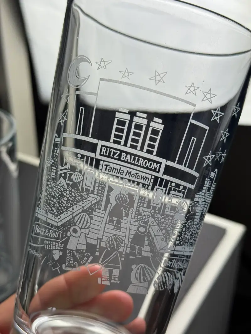 A glass engraved with an artist’s original artwork