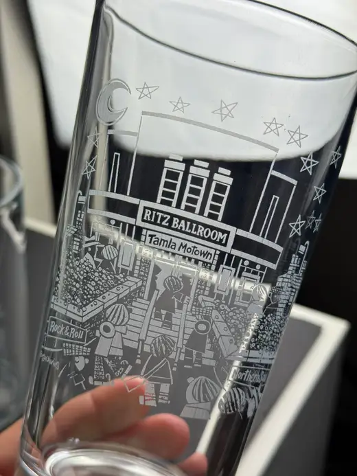 A glass engraved with an artist’s original artwork