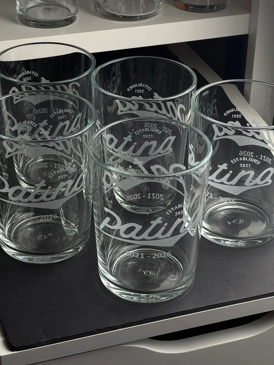 Five bodega pints engraved with a brewery logo