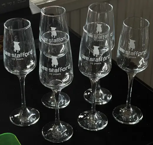 Six champagne flutes engraved to match