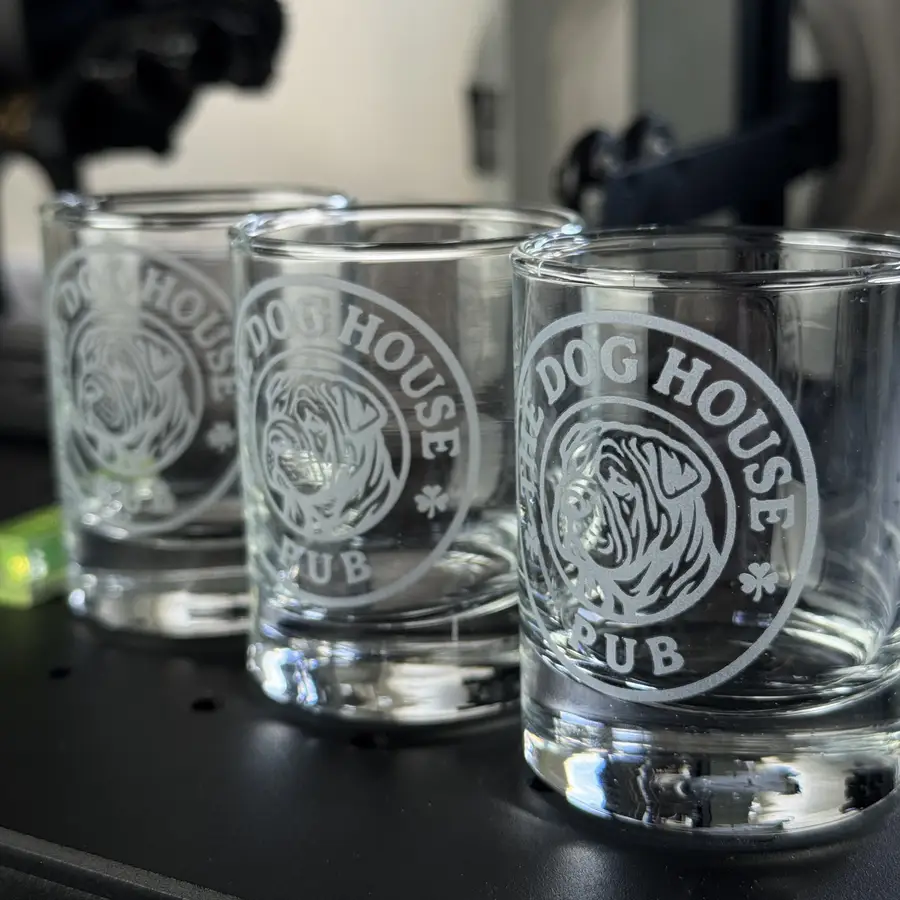 A heavy-base shot glass with an engraved logo