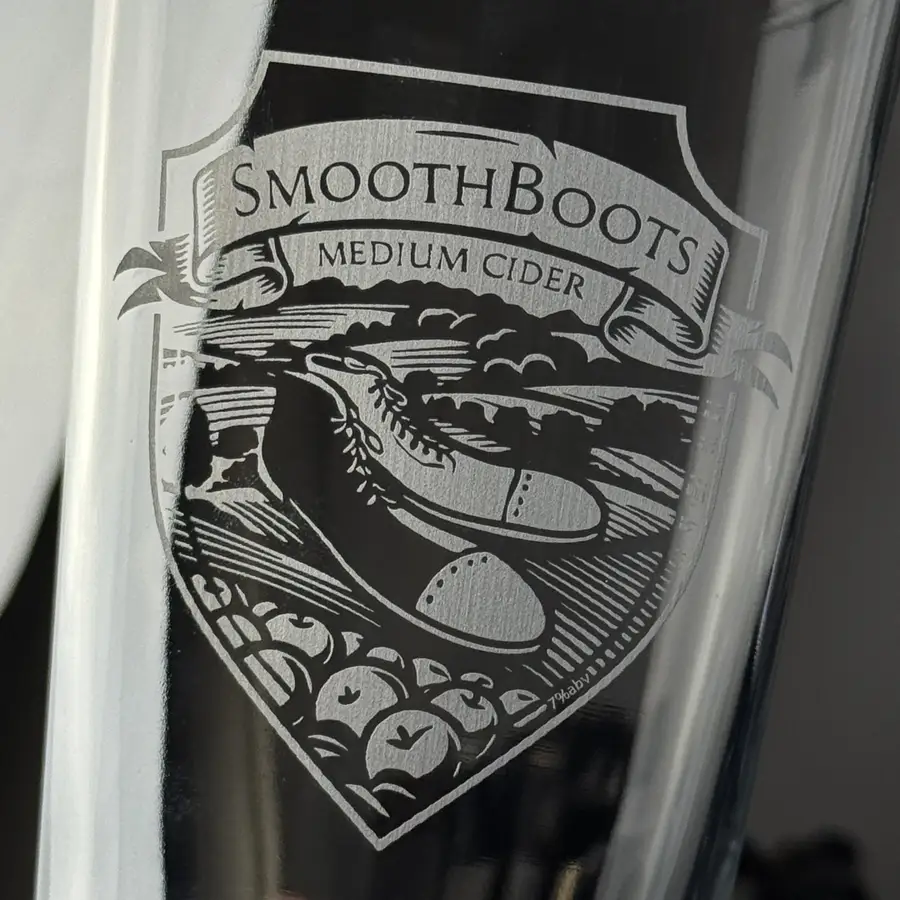 Fine engraved detail on a tulip pint, showing thin lines and small type