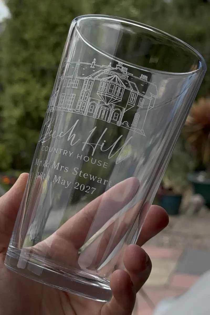 A conical pint engraved with names and a wedding date