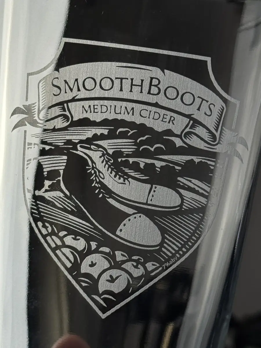 Close-up of a UV laser engraving: fine hatching, thin outlines and legible small type, with a smooth even frost